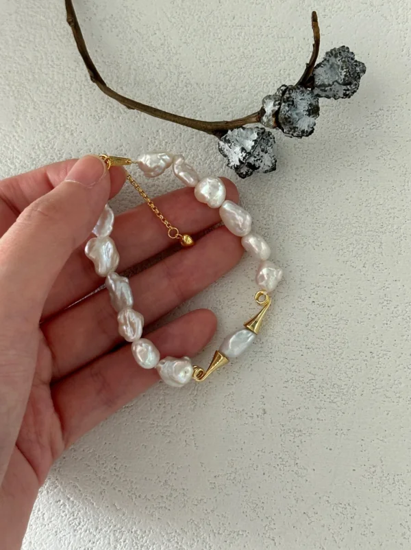 Baroque Pearl Bracelet Closeโup baroque pearl bracelet in hand for scale