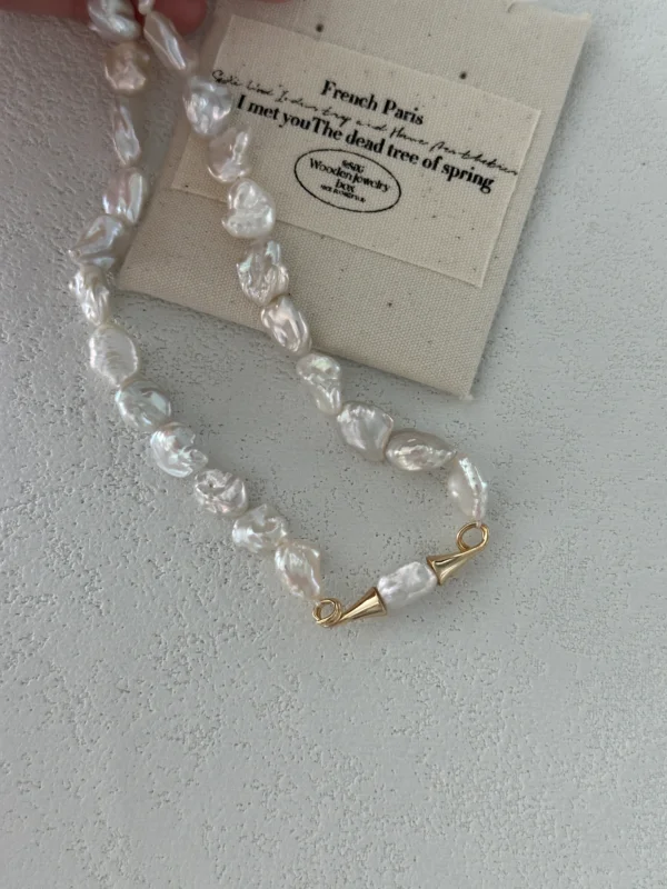 close-up baroque pearl necklace gold cone clasp