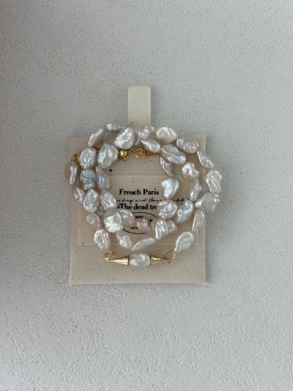 baroque freshwater pearl necklace with gold clasp on pouch