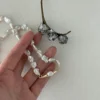 baroque pearl necklace held in hand for scale
