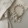 Baroque Pearl Bracelet - Large Mother-of-Pearl with Gold-Plated Finish A large Baroque pearl bracelet made of mother-of-pearl with a gold-plated clasp, elegantly displayed on a neutral background.