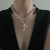 baroque pearl necklace with cross pendant layered on neck