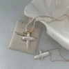 baroque pearl necklace with cross pendant on pouch