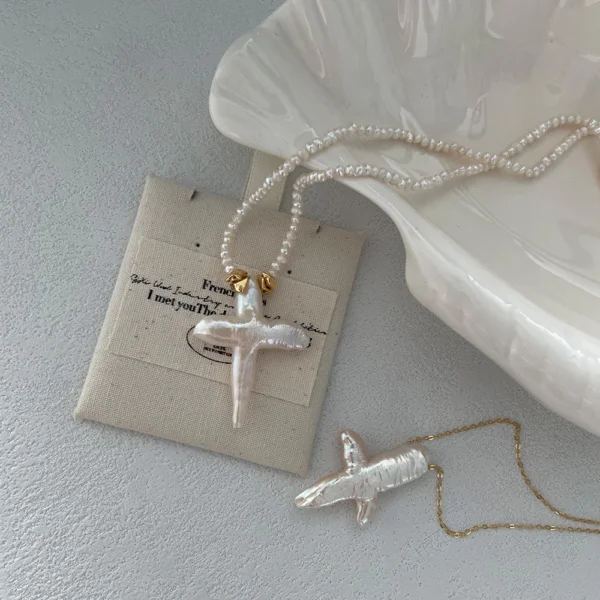 baroque pearl necklace with cross pendant on pouch