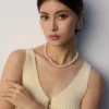 model wearing French natural pearl necklace with matching bracelet