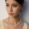 French natural pearl necklace close view at collarbone