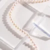 close-up strand of French natural pearl necklace on acrylic blocks