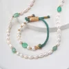 Detail of green jasper pearl necklace with gold-tone clasp and woven cord