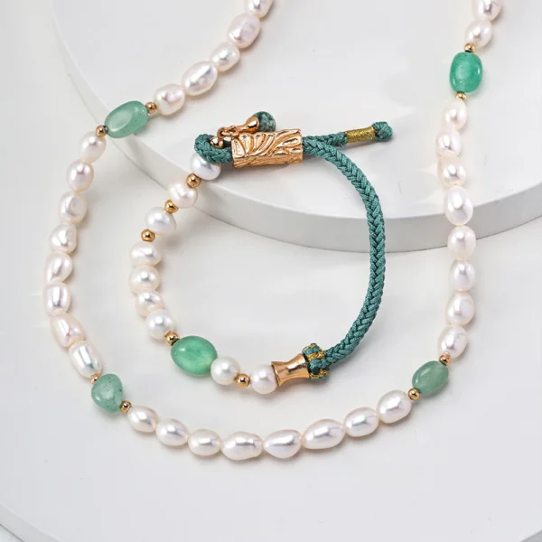 Detail of green jasper pearl necklace with gold-tone clasp and woven cord