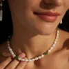 Close-up of green jasper pearl necklace worn as a delicate choker