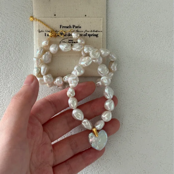 baroque pearl necklace with cross pendant on pouch
