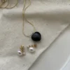 Minimalist freshwater pearl earrings styled with a delicate gold necklace
