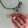 Baroque Pearl Earrings Size on Hand | Freshwater Irregular Pearls & 18K Gold-Plated Silver Baroque pearl earrings on a hand showing scale, genuine freshwater baroque pearls with irregular shape and 18k gold-plated sterling silver dangle hooks
