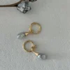Close Up Baroque Pearl Earrings | Freshwater Irregular Pearls in 18K Gold-Plated Silver Close up of baroque pearl earrings featuring genuine freshwater baroque pearls, irregular natural shapes, on 18k gold-plated sterling silver hoops