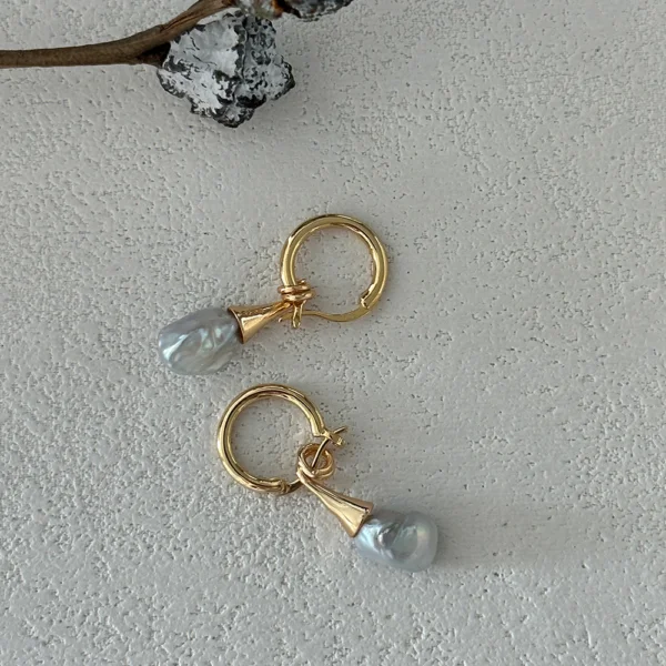 Close Up Baroque Pearl Earrings | Freshwater Irregular Pearls in 18K Gold-Plated Silver Close up of baroque pearl earrings featuring genuine freshwater baroque pearls, irregular natural shapes, on 18k gold-plated sterling silver hoops