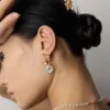 antique gold retro pearl drop earrings styled on model
