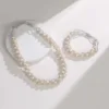 White Pearl Twist Set Flat Lay white freshwater pearl twist braided necklace and bracelet with magnetic clasp