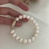 baroque freshwater pearl bracelet in hand for scale