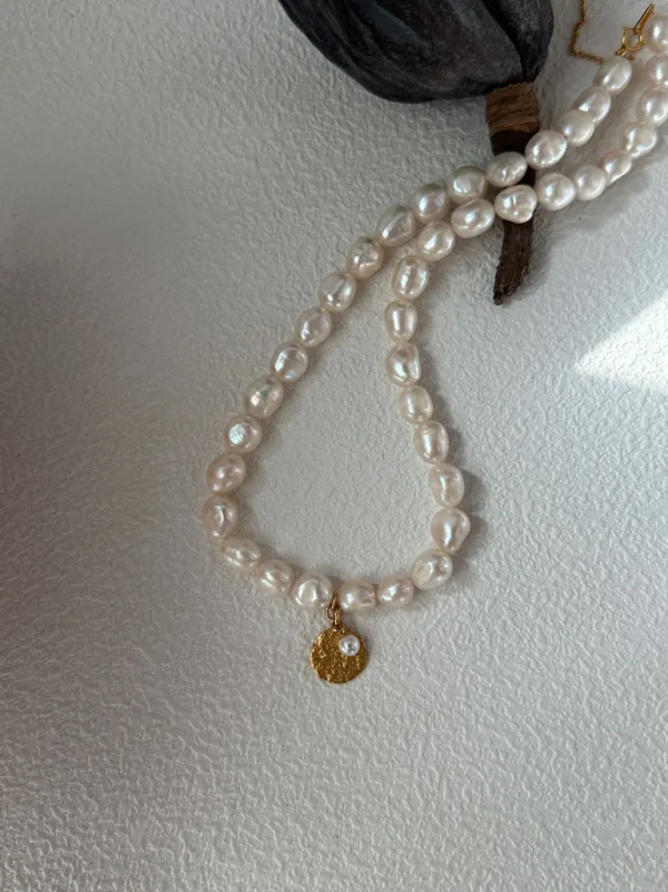 hammered yellow gold coin charm with tiny pearl on freshwater rosebud pearl necklace