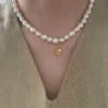 freshwater druzy rosebud pearl beaded necklace with gold coin charm, adjustable 42 cm, on neck