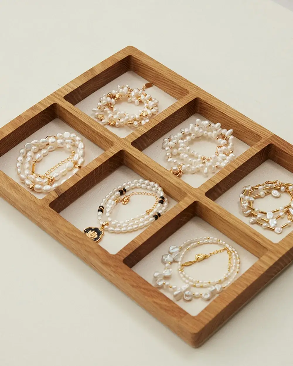 Freshwater pearl jewelry collection displayed in a wooden tray for everyday wear