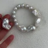 Mixed size baroque freshwater pearl bracelet displayed by hand