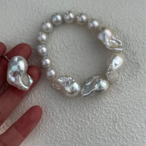 Mixed size baroque freshwater pearl bracelet displayed by hand