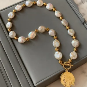 Mother of pearl necklace with baroque beads and gold-tone coin pendant