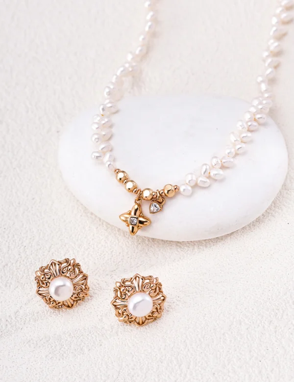 Close-up of a gold-plated freshwater pearl necklace with sparkling CZ charm details