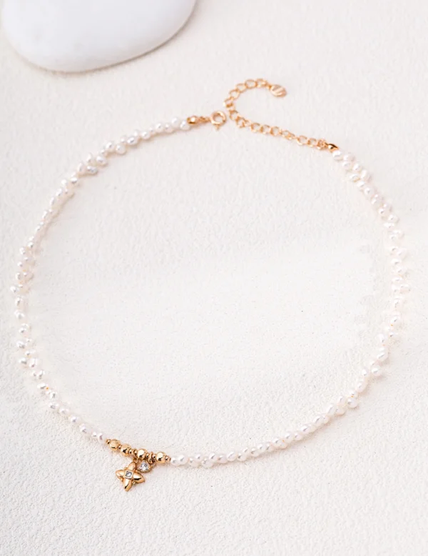 Gold-plated freshwater pearl necklace with 3–4mm pearls and CZ charms