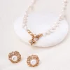 pearl stud earrings gold styling Gold-tone pearl stud earrings styled with pearl jewelry for an elegant feminine look