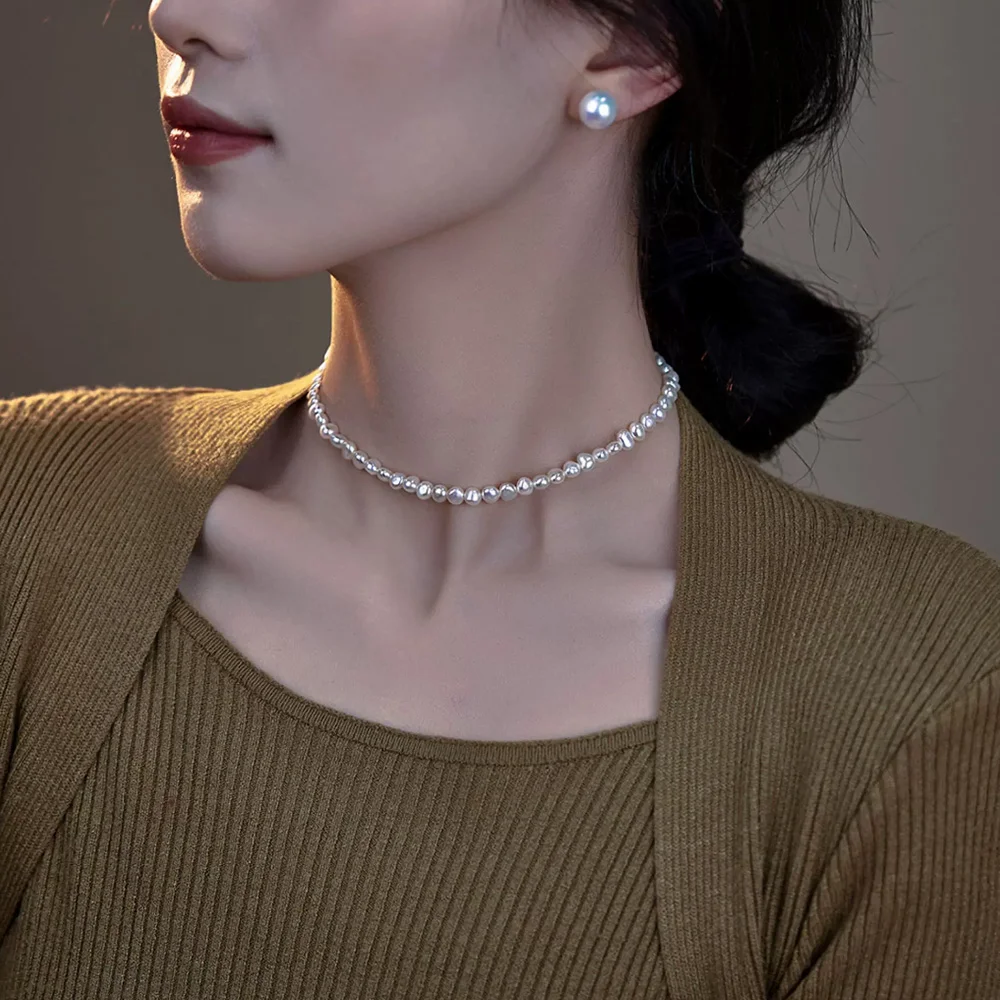 14-inch pearl necklace worn close to the neck with a brown ribbed top