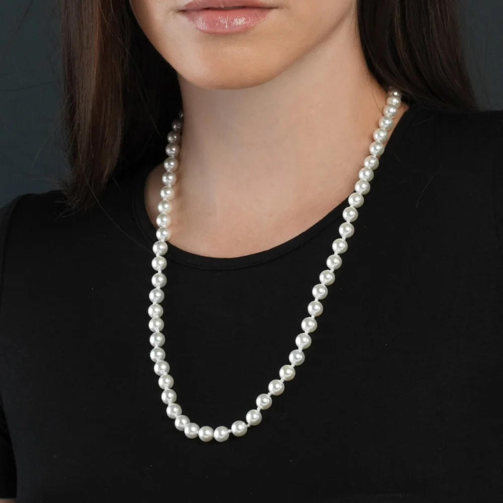 24-inch white pearl necklace worn on a model with a black top
