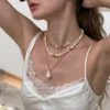 Close-up of a model wearing layered baroque freshwater pearl necklaces with gold-tone accents