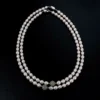 Full view of freshwater pearl necklaces with jade accent beads arranged on a black background