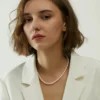 Minimalist Freshwater Pearl Necklace for Women Woman wearing a minimalist white freshwater pearl necklace with a blazer
