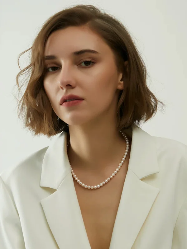 Minimalist Freshwater Pearl Necklace for Women Woman wearing a minimalist white freshwater pearl necklace with a blazer