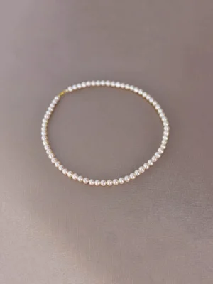 White 5.5–6mm near-round freshwater pearl necklace arranged in a circle